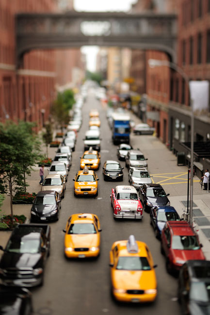 A miniature effect on a city street packed with cars