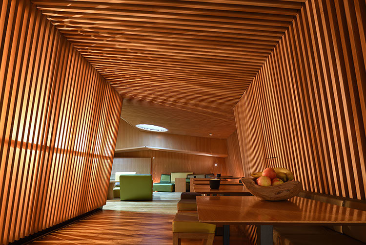 Looking down a hallway covered with a wood slatted design