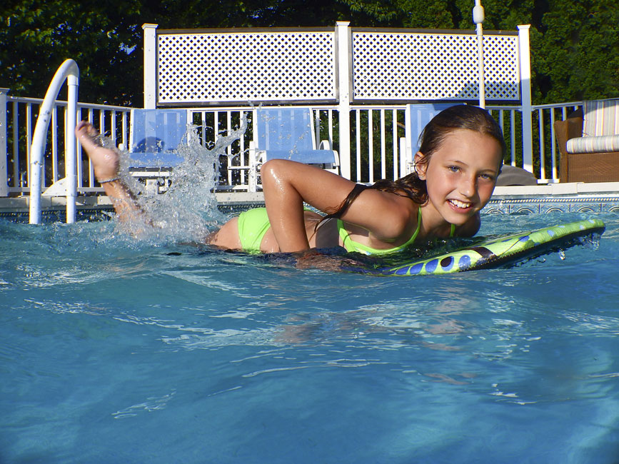 Rob Van Petten photo of a young girl in a pool on a boogie board