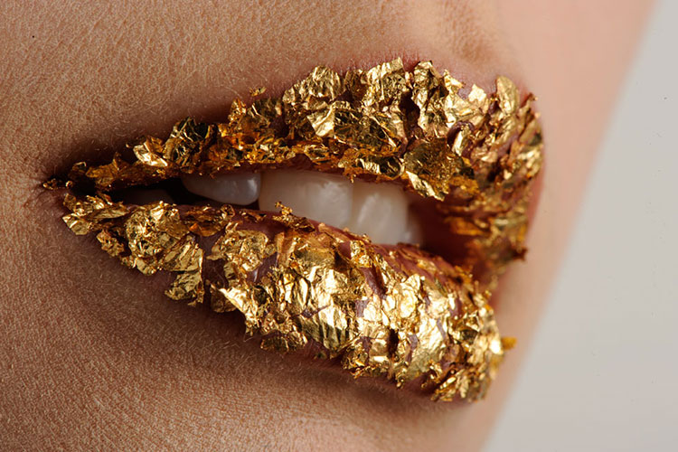 Close up of lips with gold foil applied