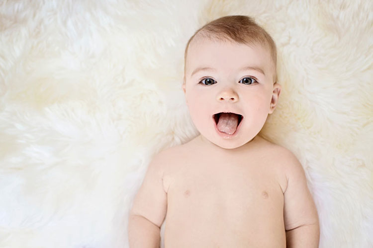 A baby making a silly face with his tongue out