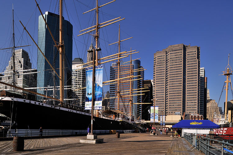 A docked ship with a cityscape in the background