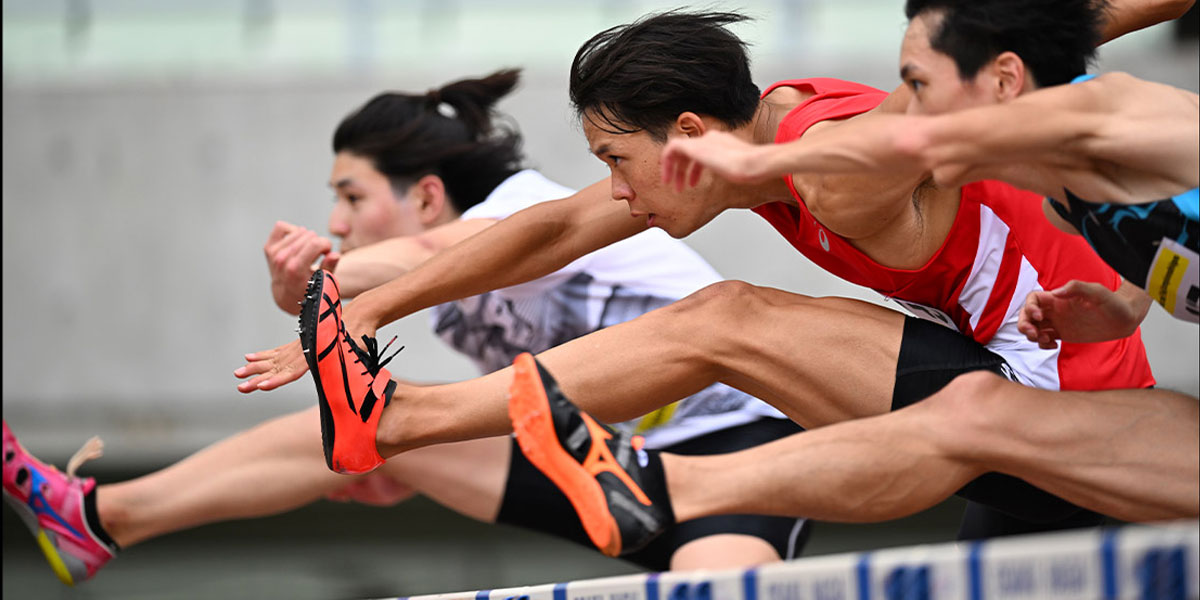 Photo of three hurdlers in mid air