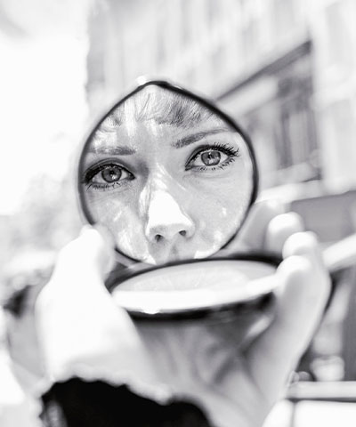 Photo of a girl's reflection in a compact mirror, held in a hand, in B&W, taken with the Z f camera