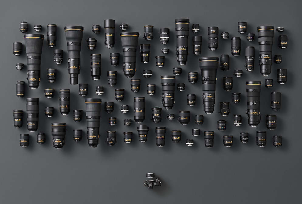 Family shot of a Z series mirrorless camera and the Mount Adapter FTZ with dozens and dozens of F-mount NIKKOR lenses