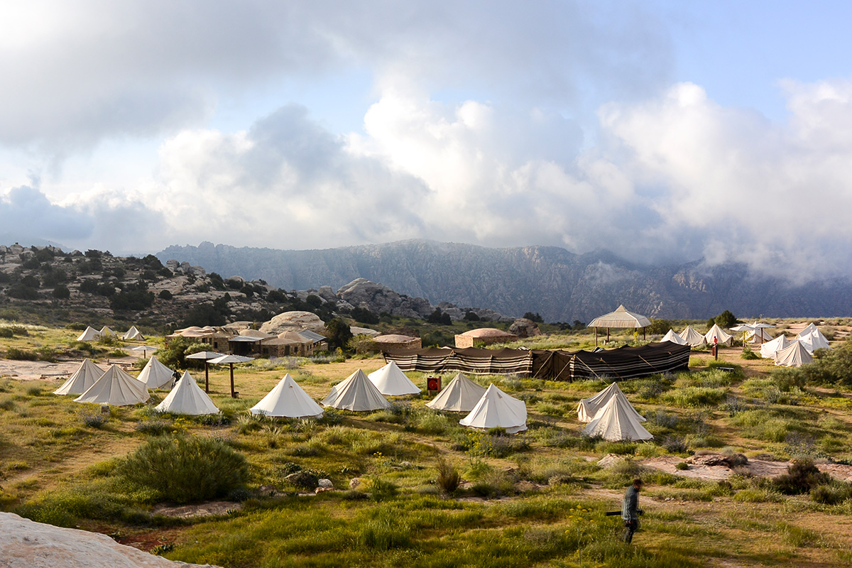 Erika Wiggins photo of tents in a field with mountains in the background