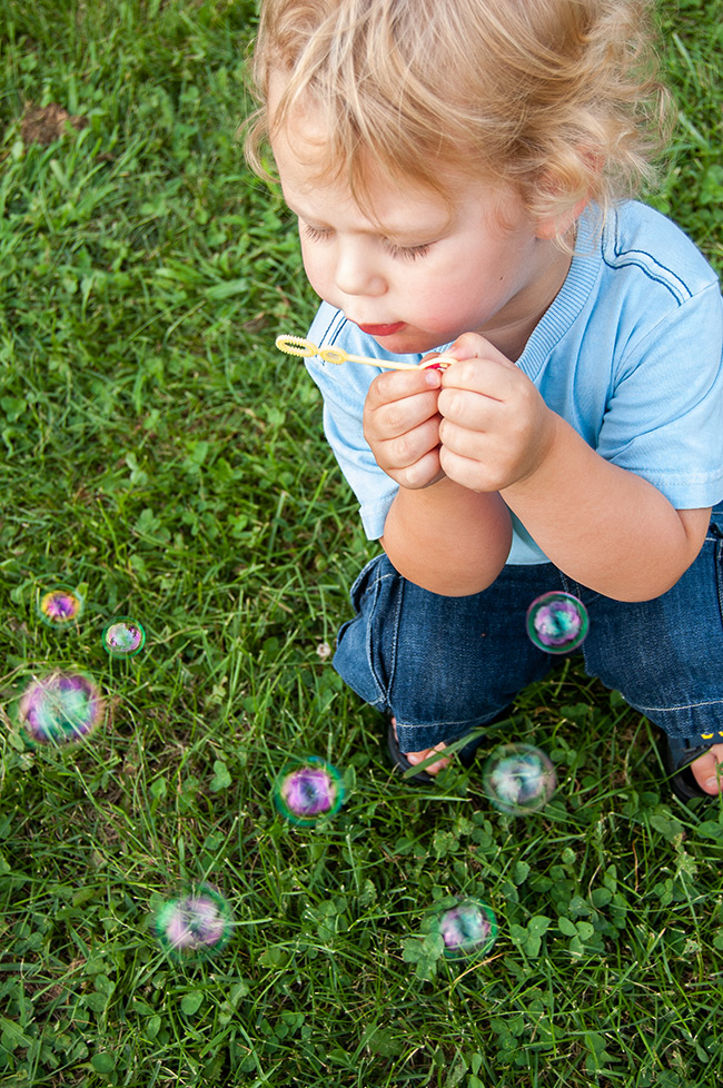 Kathy Wolfe photo of a young boy blowing bubbles